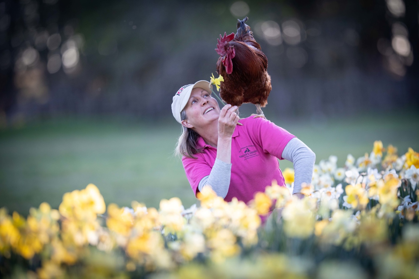 Edgars Mission Pam Ahern with Red Baron the rooster